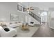 Bright and airy living room featuring hardwood floors, high ceilings, and staircase at 10957 Norcross Cir, Orlando, FL 32825