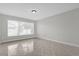 Sunny living room with tiled floors and a large bright window at 10957 Norcross Cir, Orlando, FL 32825