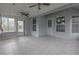 Enclosed porch features tile flooring, ceiling fans, and windows with views of the yard at 10957 Norcross Cir, Orlando, FL 32825