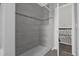Shower room features updated tiling, shower head, and recessed shelf at 10957 Norcross Cir, Orlando, FL 32825