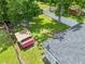 Aerial view of the backyard, shed, home, and perimeter fencing of the property at 1501 Delaware Ave, St Cloud, FL 34769