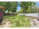 Large grassy backyard with a partial view of a playset at 1501 Delaware Ave, St Cloud, FL 34769