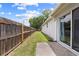Fenced backyard showing the property line and the home's exterior at 1501 Delaware Ave, St Cloud, FL 34769
