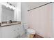 Bathroom featuring white vanity with wood countertop, tiled floors, and a shower/tub combo at 1501 Delaware Ave, St Cloud, FL 34769