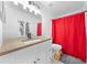 Bright bathroom featuring a stylish wood countertop, modern fixtures, and a vibrant red shower curtain at 1501 Delaware Ave, St Cloud, FL 34769