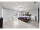 Comfortable bedroom featuring large windows, tile floor, ceiling fan, and a coordinating dresser and night stand at 1501 Delaware Ave, St Cloud, FL 34769