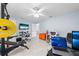 Versatile bonus room featuring work out equipment, desk, and tv at 1501 Delaware Ave, St Cloud, FL 34769
