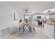 Cozy dining area next to an open kitchen featuring modern appliances and natural light at 1501 Delaware Ave, St Cloud, FL 34769
