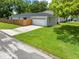 Charming single-story home with a well-maintained lawn and an attached two-car garage at 1501 Delaware Ave, St Cloud, FL 34769
