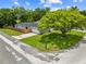 Street view of a well-maintained home with a large tree shading the front yard at 1501 Delaware Ave, St Cloud, FL 34769