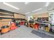 Well-organized garage with abundant shelving, storage, and workspace for hobbyists or professionals at 1501 Delaware Ave, St Cloud, FL 34769