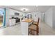 Modern kitchen featuring white cabinets, stainless steel appliances, and a butcher block island with seating at 1501 Delaware Ave, St Cloud, FL 34769