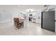 Spacious kitchen featuring white cabinets, stainless steel appliances, tile floor, and a breakfast bar with seating at 1501 Delaware Ave, St Cloud, FL 34769