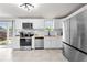 Bright kitchen featuring white cabinets, stainless steel appliances, and tile flooring at 1501 Delaware Ave, St Cloud, FL 34769