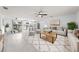 Bright, open-concept living area with modern tile floors, neutral decor, and a ceiling fan at 1501 Delaware Ave, St Cloud, FL 34769