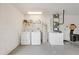 Well-lit utility area with washer, dryer, water heater, and HVAC system, providing practical functionality at 1501 Delaware Ave, St Cloud, FL 34769