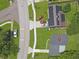 An aerial view of a home with solar panels, green lawn, driveway, and street access at 2806 Bonneville Dr, Orlando, FL 32826