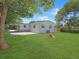 Spacious backyard with plenty of green grass and mature trees at 2806 Bonneville Dr, Orlando, FL 32826
