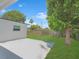 Well-maintained backyard with a concrete patio and lush green lawn at 2806 Bonneville Dr, Orlando, FL 32826