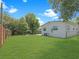 Manicured backyard showing the side and rear of the home and lawn at 2806 Bonneville Dr, Orlando, FL 32826