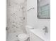 Modern bathroom featuring marble-style tile in the shower with glass doors and new white vanity at 2806 Bonneville Dr, Orlando, FL 32826