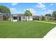 Inviting single-story home featuring a well-manicured lawn and convenient carport at 2806 Bonneville Dr, Orlando, FL 32826