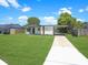 Inviting single-story home featuring a well-manicured lawn and convenient carport at 2806 Bonneville Dr, Orlando, FL 32826
