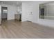 Open-concept living area with sleek wood floors, seamlessly connecting to kitchen with stainless steel appliances at 2806 Bonneville Dr, Orlando, FL 32826