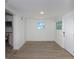 Well-lit room with wood-look flooring and a doorway, adjacent to the modern kitchen at 2806 Bonneville Dr, Orlando, FL 32826