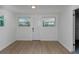 Bright room features wood-look flooring, beadboard paneling, windows and a door at 2806 Bonneville Dr, Orlando, FL 32826