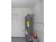 Water heater on concrete base with fresh paint cans and plumbing at 2806 Bonneville Dr, Orlando, FL 32826