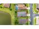 Drone shot outlining the property's boundaries, showcasing backyard near the lake and screen enclosed pool in neighborhood at 2823 Sail Breeze Way, Kissimmee, FL 34744