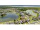Overhead view of a lakeside community, highlighting the property location near a lake and green spaces at 2823 Sail Breeze Way, Kissimmee, FL 34744