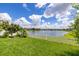 Picturesque backyard with a lush lawn and a tranquil lake at 2823 Sail Breeze Way, Kissimmee, FL 34744