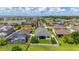 Aerial view of home's backyard and screen enclosed pool near a lake, surrounded by lush landscaping at 2823 Sail Breeze Way, Kissimmee, FL 34744