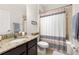Bathroom features a granite countertop, sink, tile floor, and shower at 2823 Sail Breeze Way, Kissimmee, FL 34744