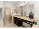 Bathroom featuring a glass-enclosed shower, granite countertops, and dark wood cabinetry at 2823 Sail Breeze Way, Kissimmee, FL 34744