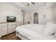 Neutral bedroom featuring light wood-look floors, dresser and an adjacent doorway at 2823 Sail Breeze Way, Kissimmee, FL 34744