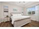 Bright bedroom featuring wood-look floors, tray ceiling, and a rustic wood-trimmed bed frame at 2823 Sail Breeze Way, Kissimmee, FL 34744