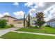 Inviting home features lush landscaping, a brick driveway and attached two-car garage in residential neighborhood at 2823 Sail Breeze Way, Kissimmee, FL 34744
