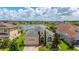 Inviting home features lush landscaping, a brick driveway and attached two car garage with a picturesque lake view at 2823 Sail Breeze Way, Kissimmee, FL 34744