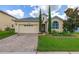 Charming one-story home with attached two-car garage, brick driveway and meticulously maintained landscaping at 2823 Sail Breeze Way, Kissimmee, FL 34744