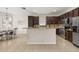 Kitchen with island, tile floor, stainless steel appliances and pendant lighting at 2823 Sail Breeze Way, Kissimmee, FL 34744