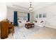 Open living room with white sofas, a piano, and large windows with dark-blue curtains at 2823 Sail Breeze Way, Kissimmee, FL 34744