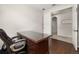 Home office with a large, dark-wood desk and hardwood flooring with hallway access at 2823 Sail Breeze Way, Kissimmee, FL 34744