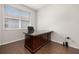 Bright home office featuring a large, dark-wood desk, hardwood flooring, and a window at 2823 Sail Breeze Way, Kissimmee, FL 34744