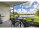 Screened-in patio with a view of the landscaped backyard and tranquil pond at 2823 Sail Breeze Way, Kissimmee, FL 34744