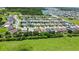 An aerial view of a residential neighborhood with well-maintained houses, lush greenery and a lake at 2829 Shelburne Way, St Cloud, FL 34772