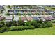 An aerial shot of homes in a residential area near a lake and forest at 2829 Shelburne Way, St Cloud, FL 34772