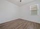 Bedroom with a window and wood-look flooring, offering a bright and modern look at 2829 Shelburne Way, St Cloud, FL 34772